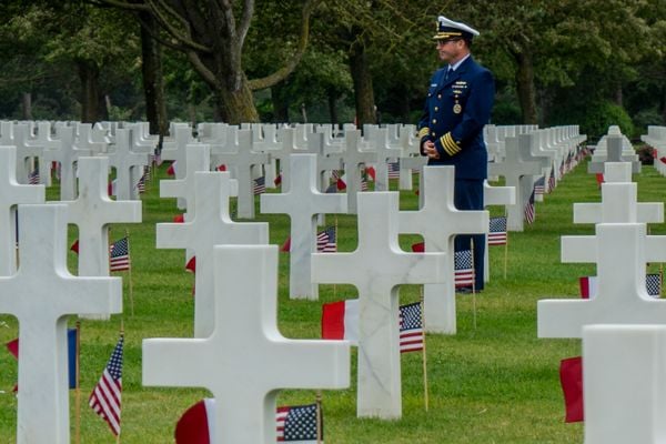 Military man standing at a military cemetery thumbnail