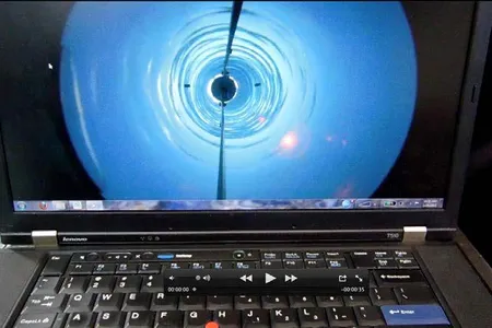 A camera passes down through the borehole.