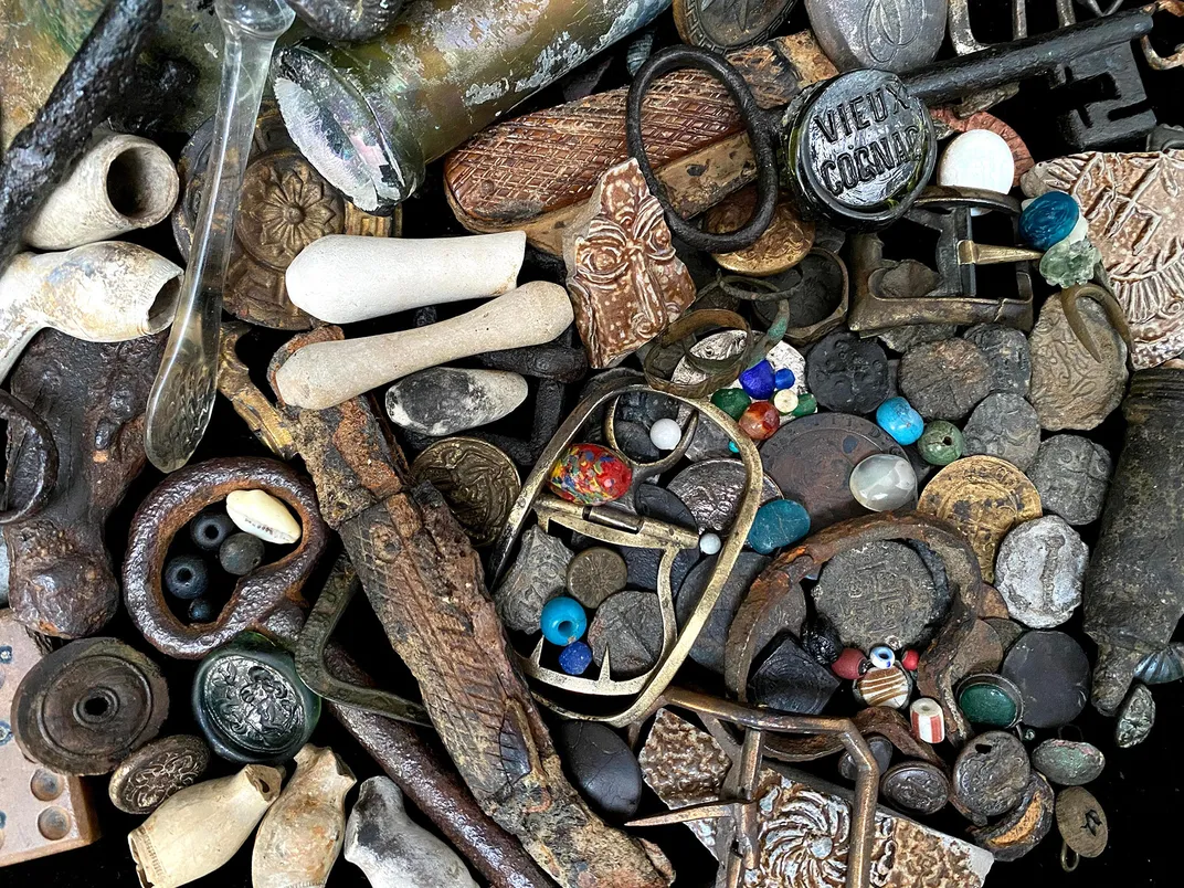 Belt buckles, knives, coins, tokens, wig curlers, bottle seals, trade beads and keys found by Monika Buttling-Smith on the Thames foreshore