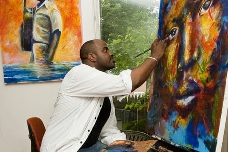 Local artist Jay Coleman works on one of his vibrant, evocative portraits in his studio in Northwest Washington, DC.