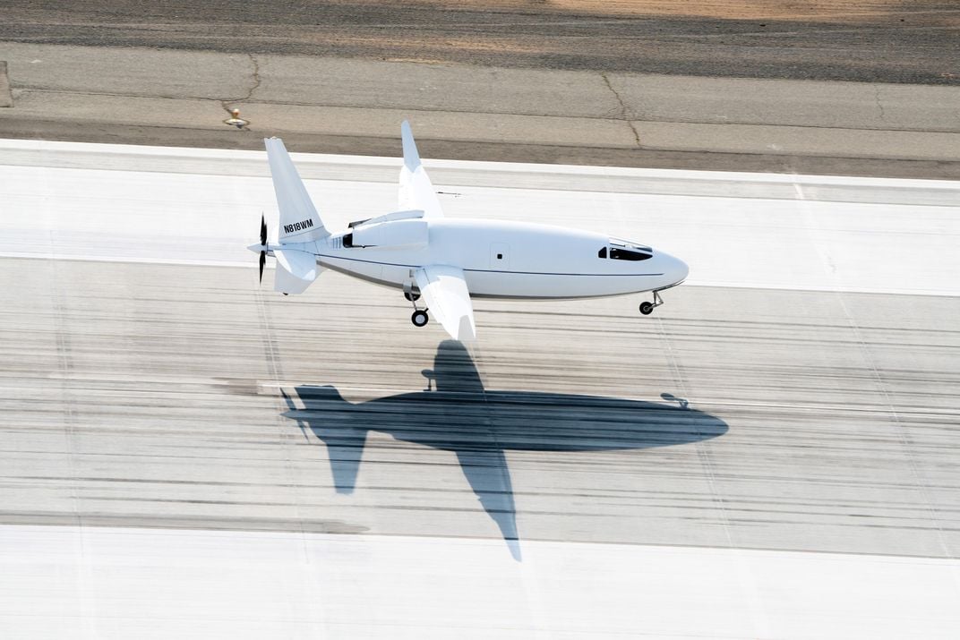 Celera touching down, with shadow on runway