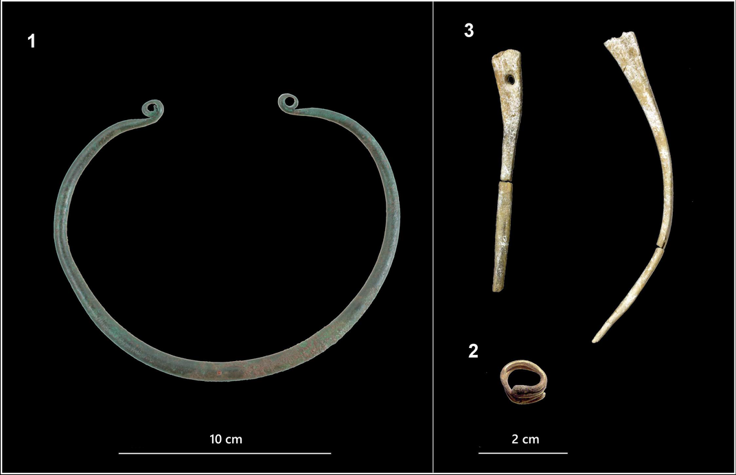 The urn's grave goods included a bronze neck-ring (left), two bone hair pins and a gold hair-ring (right).