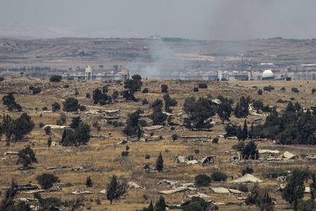 Smoke rises over a Syrian village that has been recently shelled