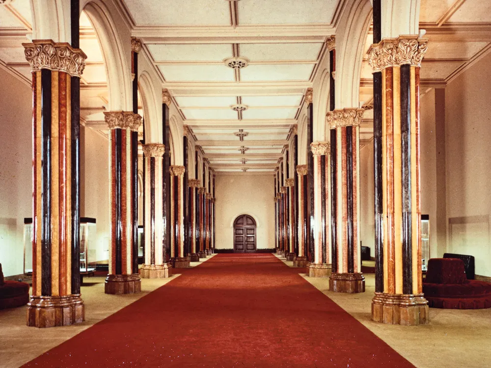 a red carpet surrounded by marble columns