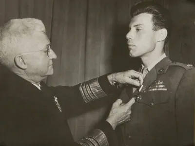 Peter J. Ortiz receives the first of the two Navy Crosses he was awarded for extraordinary heroism during World War II.
