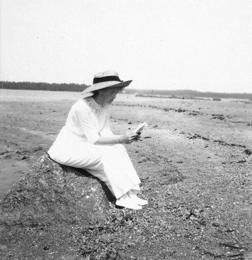 A 1911 photo of Olga reading on a beach in Finland