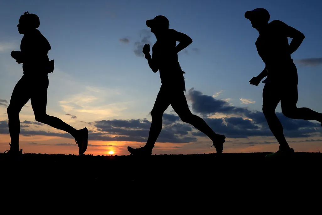 Runners In Hawaii At Sunset