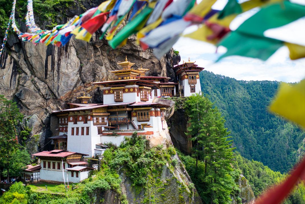 Cliff-side Taktsang Monastery with prayer flags, Bhutan