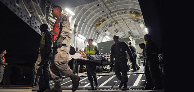 Wounded service members are taken off a C-17