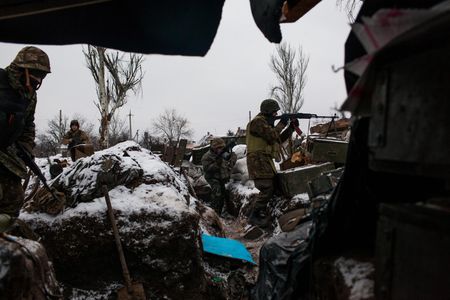Members of Sich Battalion, a pro-Ukrainian volunteer force formed in 2015, provide cover fire for returning comrades who have fired an anti-tank rocket in a once-prosperous suburb of Donetsk. Volunteer units have since been integrated into the Ukrainian Armed Forces.