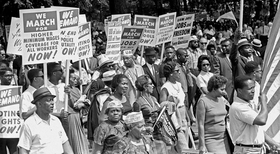 people hold signs in Washington, D.C. 