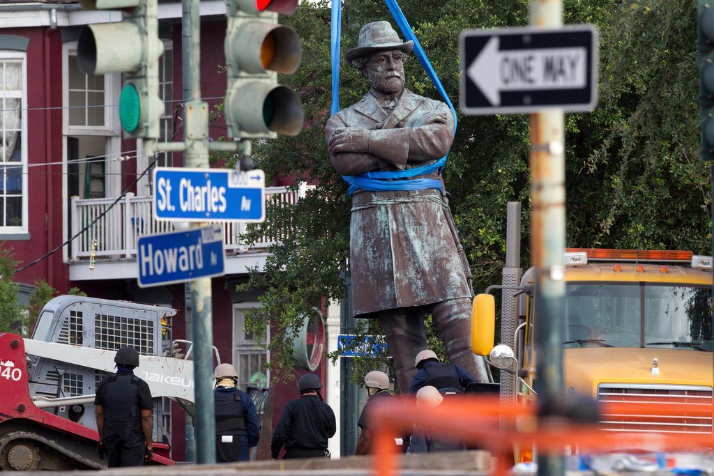 A statue of Confederate General Robert E. Lee is lowered to a truck for removal Friday, May 19, 2017, from Lee Circle in New Orleans.