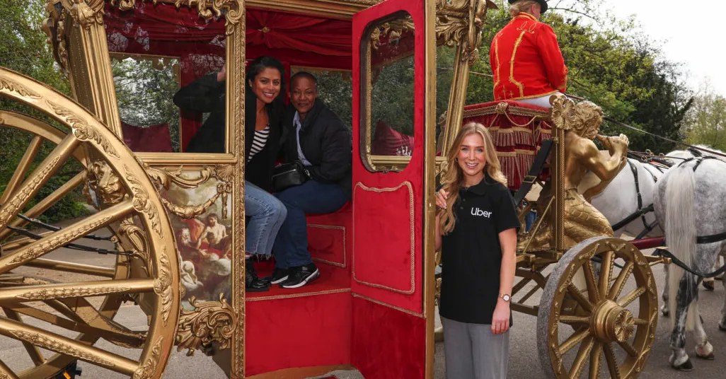 Plush red and gold carriage with people inside