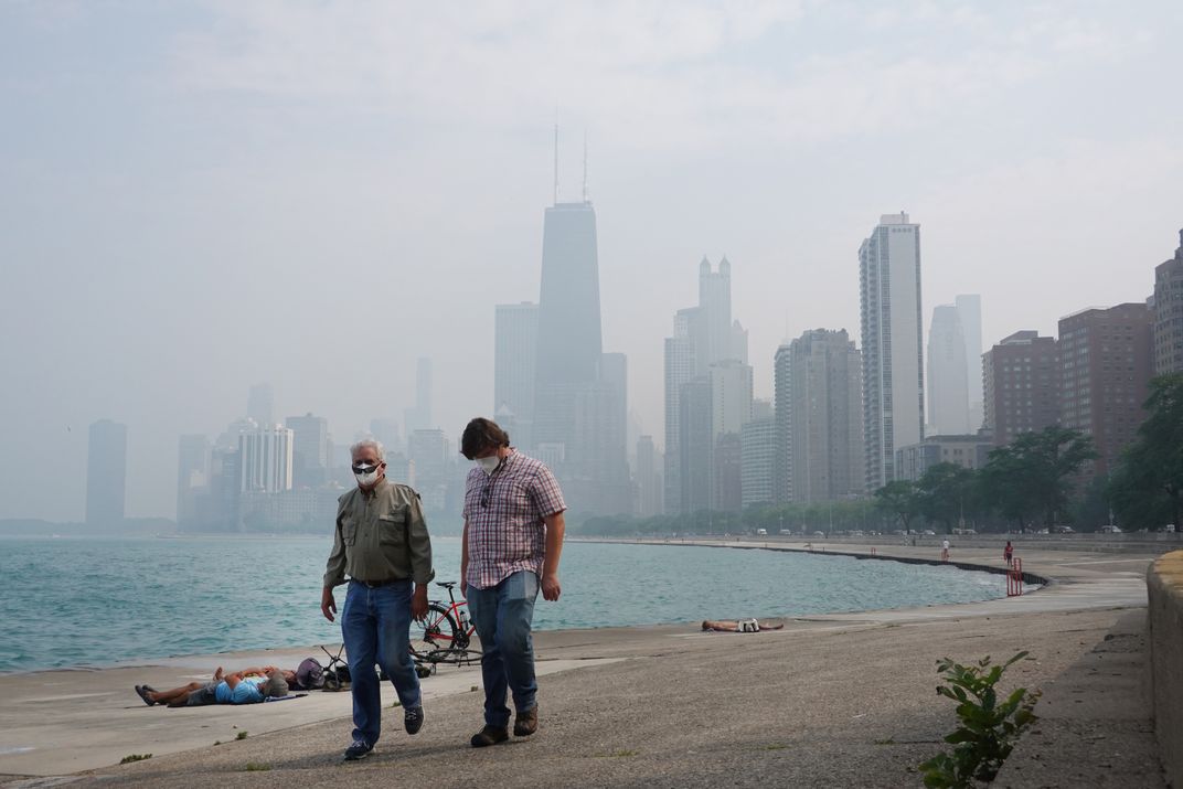 People walking with Chicago skyline behind them.