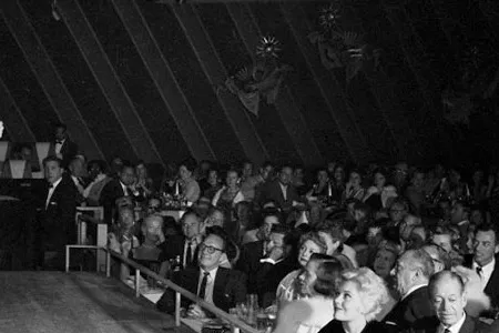 Frank Sinatra singing on the stage of the Sands Hotel.