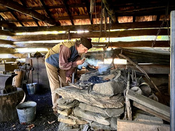 A blacksmith starts his fire. thumbnail