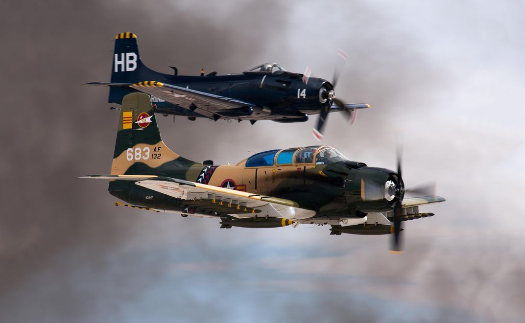 Skyraiders, more famous for attack missions than for ECM, fly fully loaded at a 2014 airshow. 