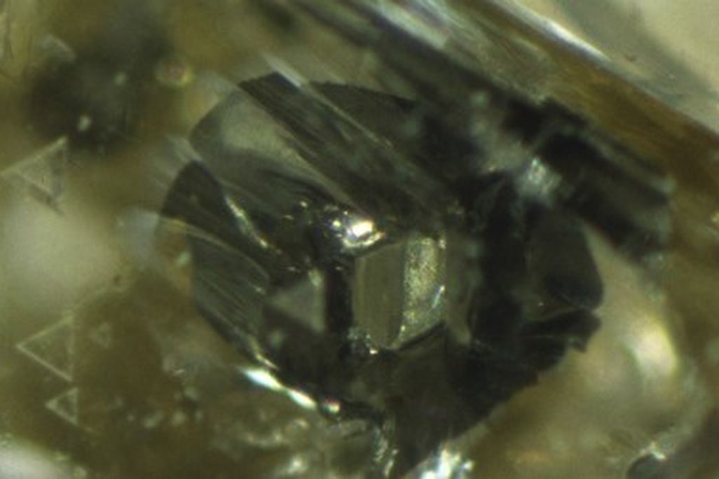 A hexagonal grain of iron sulfide in a diamond may be a flaw for jewelers, but it's useful data for scientists