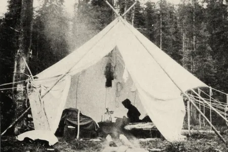 Mrs. Walcott sketching a wild flower in water colors on a frosty morning in camp.