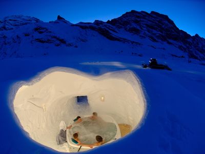 A group enjoys an igloo hot tub at Iglu-dorf.