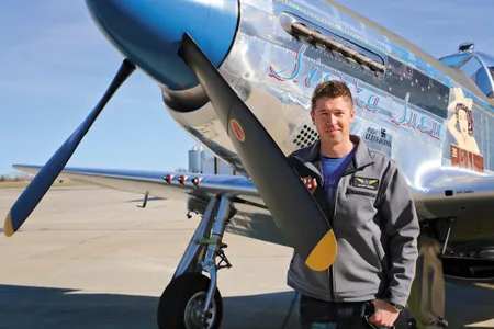 At Bemidji Airport, Erik Hokuf stands with a recent project, the P-51D Sierra Sue II. The Mustang won owner Paul Ehlen an EAA 2015 Grand Reserve Champion award and Hokuf’s team, a Gold Wrench.