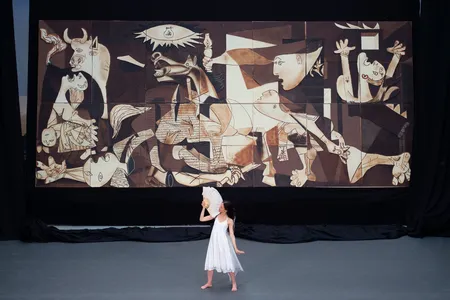 A dancer performs during the public presentation of a life-size chocolate version of Picasso's Guernica.