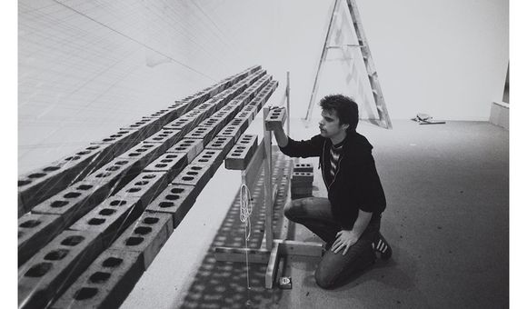 Photograph of Loren Madsen with sculpture Inverted Pyramid, Floating at Hirshhorn Museum and Sculpture Garden, 1979 / unidentified photographer. Loren Madsen papers, 1969-2017. Archives of American Art, Smithsonian Institution.