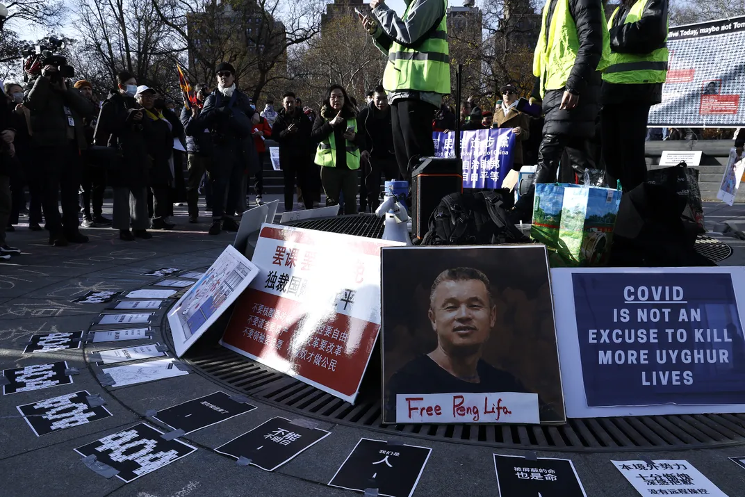 Signs and photographs displayed in Manhattan's Washington Square Park during a December 4 rally in support of anti-government protests in China