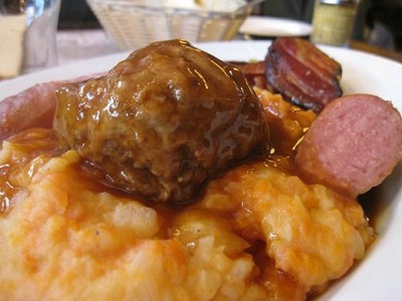 Hutspot Dutch, hochepot French or hotchpotch English, is a dish of boiled  and mashed potatoes, carrots and onions close up in the bowl on the table.  V Stock Photo - Alamy