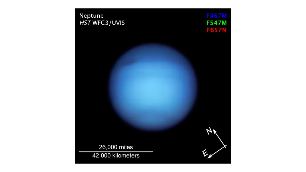 An image of Neptune. The planet is a deep sapphire color.