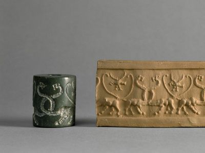 A cylinder seal (left) engraved with symbols that was used to press markings into wet clay (right)