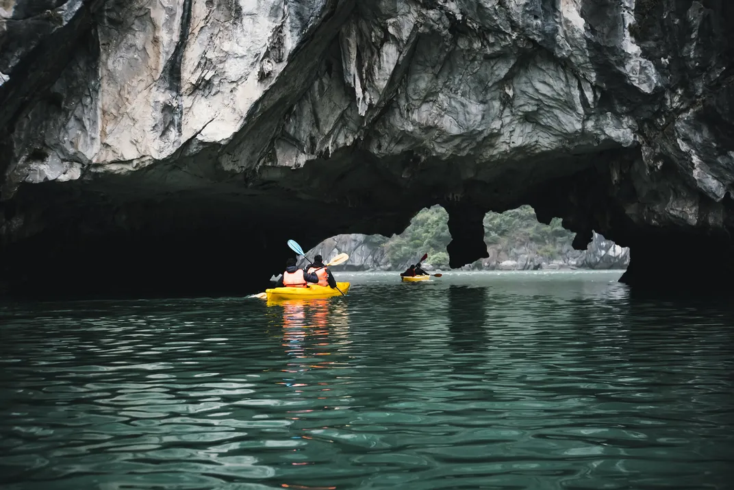 Kayaking among dramatic rock formations of Ha Long Bay