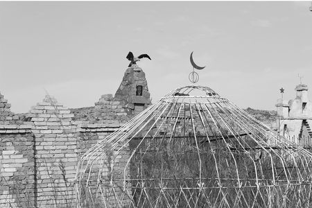 The yurt, a portable, circular hut, has been a part of Central Asian nomadic culture for centuries. During the Soviet era, metal was abundant and cheap, so metallic yurts frequent Kyrgyzstan ancestral cemeteries. An Islamic crescent tops this yurt, and a Kyrgyz hunting eagle spreads its wings in the background.