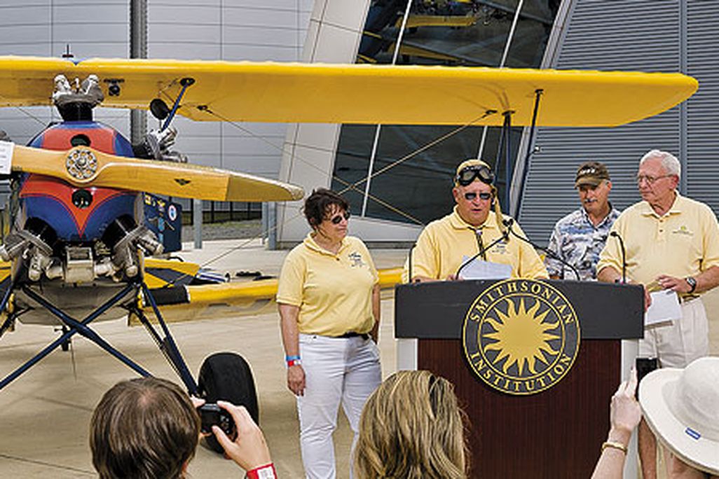 An emotional Gene Breiner (at lectern, with daughter Joyce and General Jack Dailey, director of the National Air and Space Museum) donated Plane Jane to the Museum this past June in hopes of inspiring future pilots.