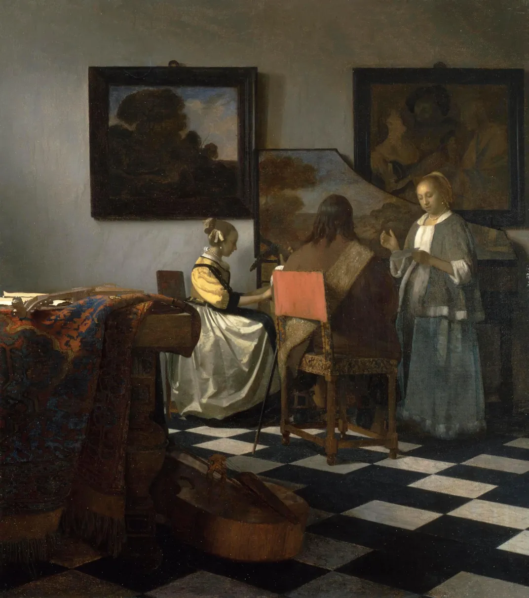 An interior domestic scene of two women and a man performing music 