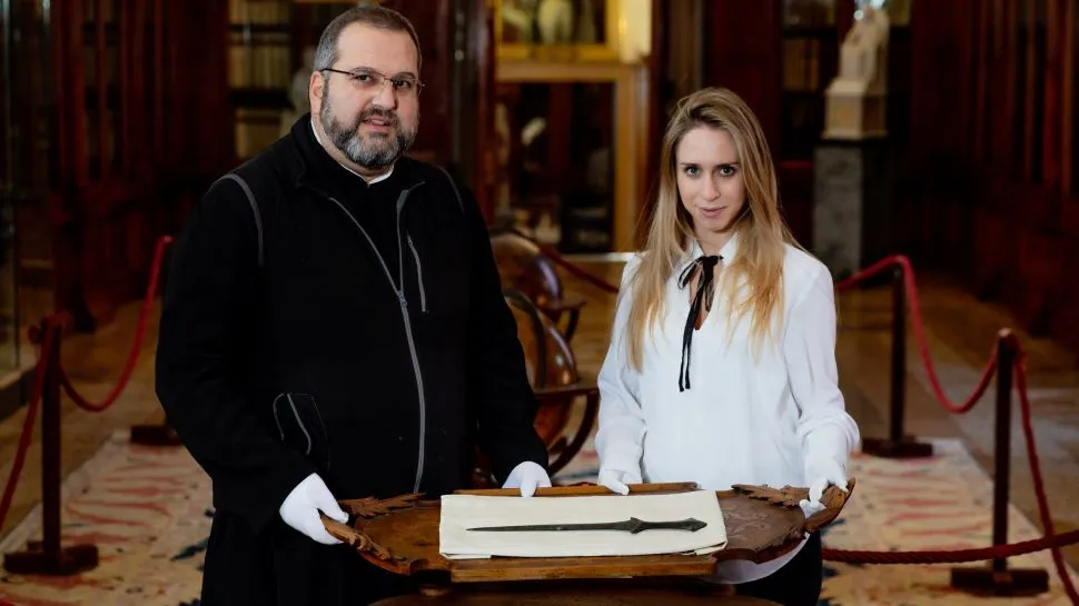 Archaeologists with sword