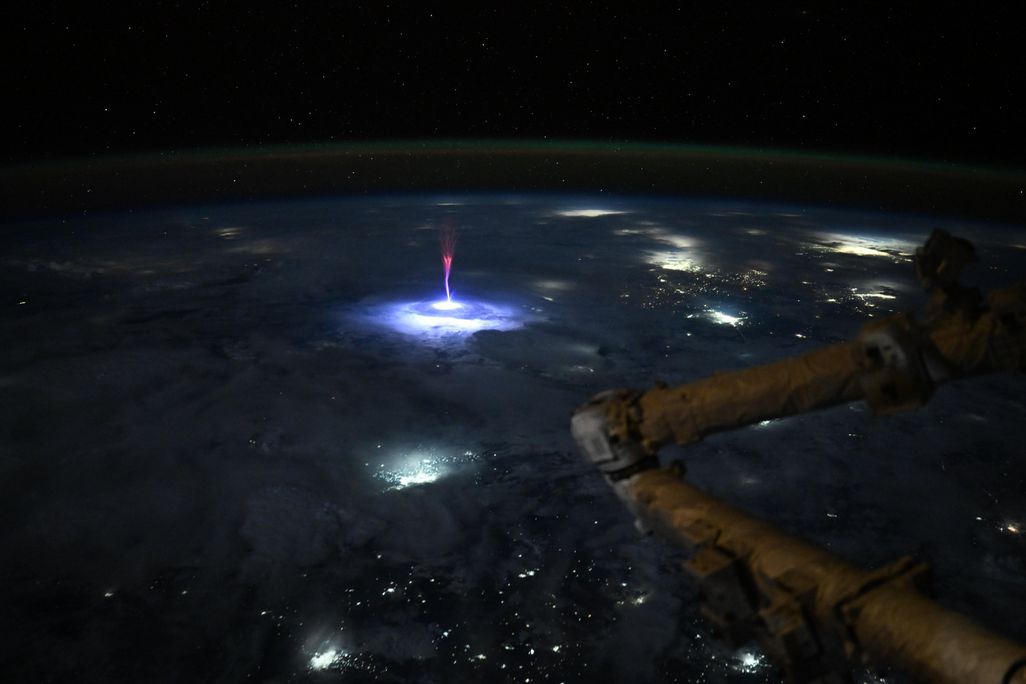 a red flash of light above clouds