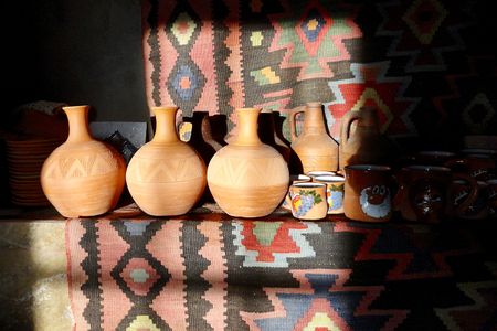 At Sisian Ceramics, Vahagn Hambardzumyan throws clay on a wheel to make traditional Armenian shapes onto which Zara Gasparyan etches decorative patterns. The terracotta jugs on the left are made to hold water.
