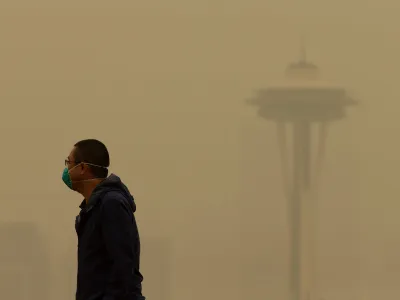 A man in Seattle wears a mask as wildfire smoke descends on the city in September of 2020.