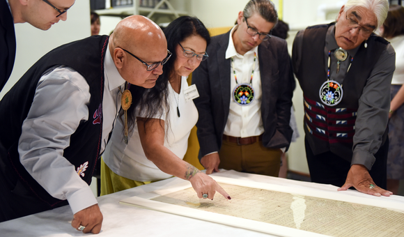 Members of a delegation from the Pokagon Band of Potawatomi Indians read names of the signers of the Treaty of Fort Wayne of 1809 as the museum prepares to place the treaty on exhibit. From left: Tribal Council Member Wayne (Alex) Wesaw, Council Chairman John P. Warren, Council Elders Representative Judy Winchester, Tribal Historic Preservation Officer; Jason S. Wesaw, and Council Vice Chairman Robert (Bob) Moody, Jr. National Museum of the American Indian, Washington, D.C., September 2017. (Kevin Wolf/AP Images for National Museum of the American Indian)