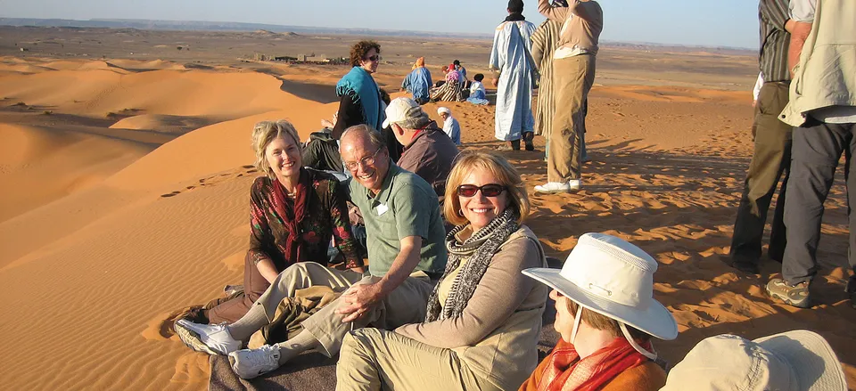 Smithsonian travelers relax on the sand dunes. Credit: Amy Kotkin