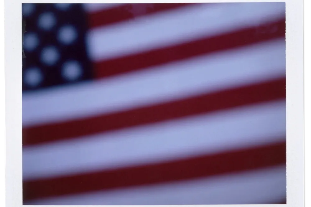 An American flag sits atop a gravestone in the cemetery of Oak Mountain Baptist Church in Shelby County, Alabama.