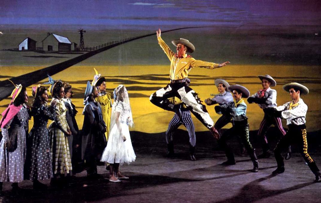 Curly McLain, played by Alfred Drake, leaps across the stage in the original 1943 production of Oklahoma!
