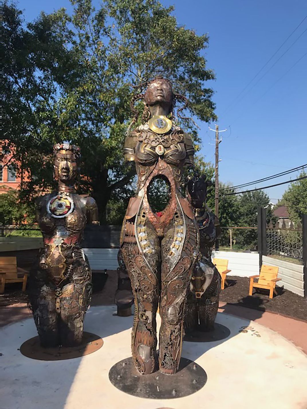 metal statue showing stylized images of three women