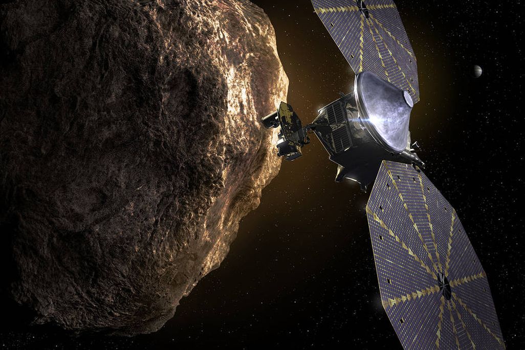 An artist rendering of NASA's Lucy space craft orbiting near one of the Trojan Asteroids