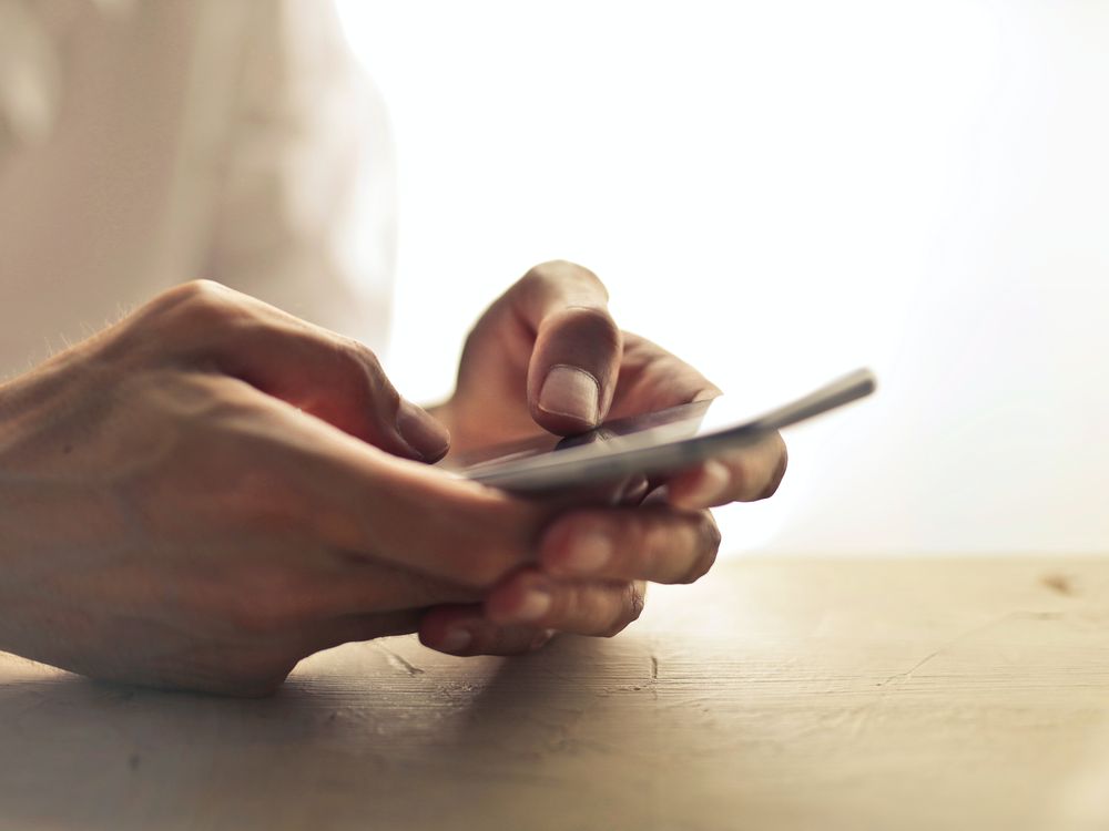 Person's hands and phone