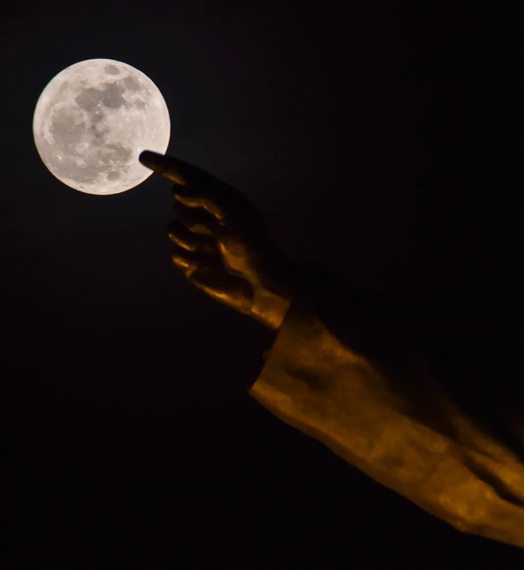 Strawberry moon rises behind the 175-foot statue of Indian social reformer Dr. B. R. Ambedkar in Hyderabad, Telangana, India, on June 29, 2026