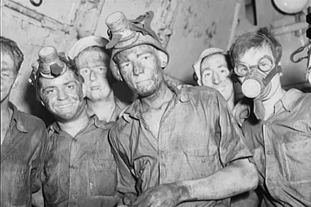Merchant Mariners aboard a training ship working in the boiler room.
