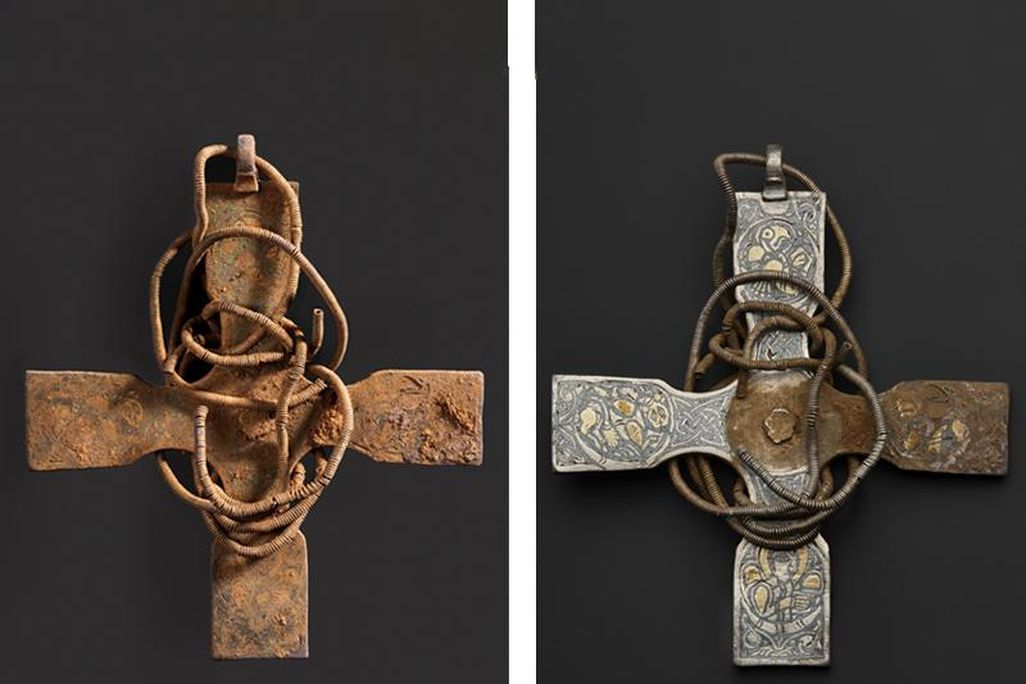Left, a square cross wrapped in what looks like metal wire; totally encrusted with reddish brown dirt; right, 3 of four arms of the cross have been cleaned, to reveal intricate engravings underneath