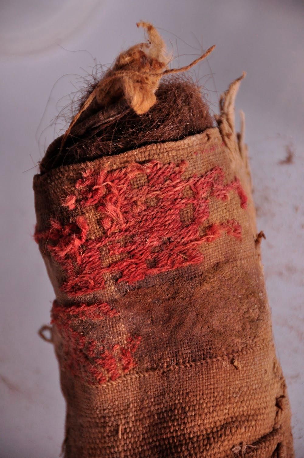A woven cloth bag stuffed with human hair.